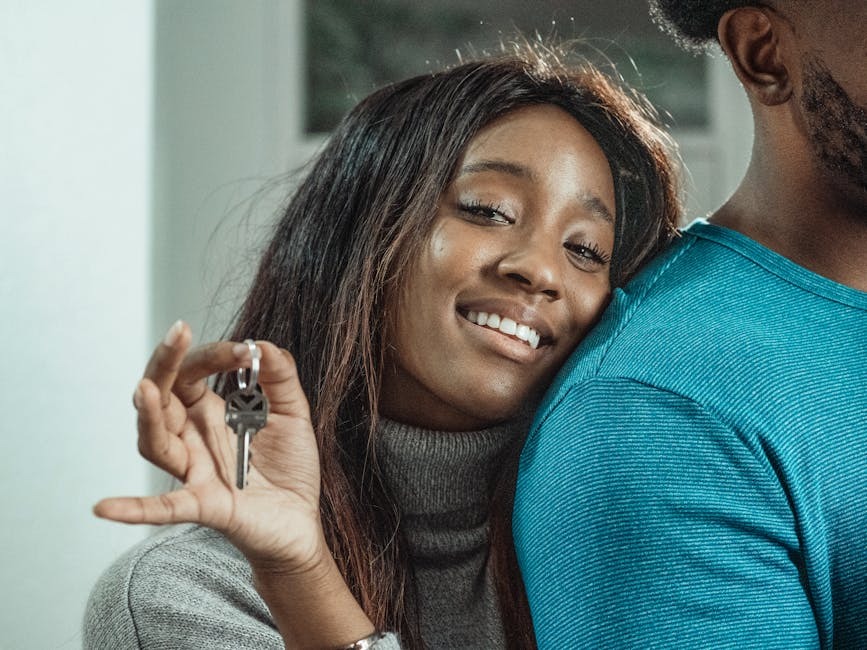 A couple holding keys to their new rental apartment after relocating